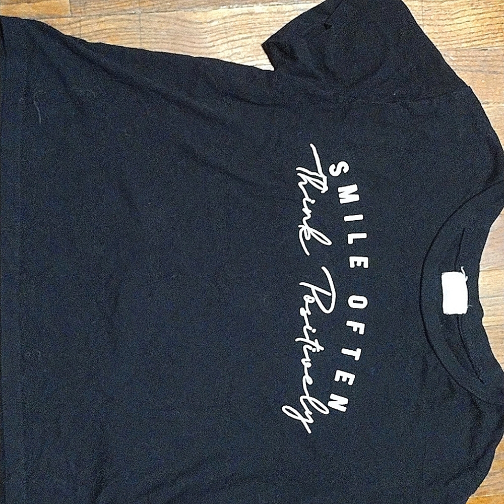 Black tees that say"smile often think positive"with sunflowers on the back